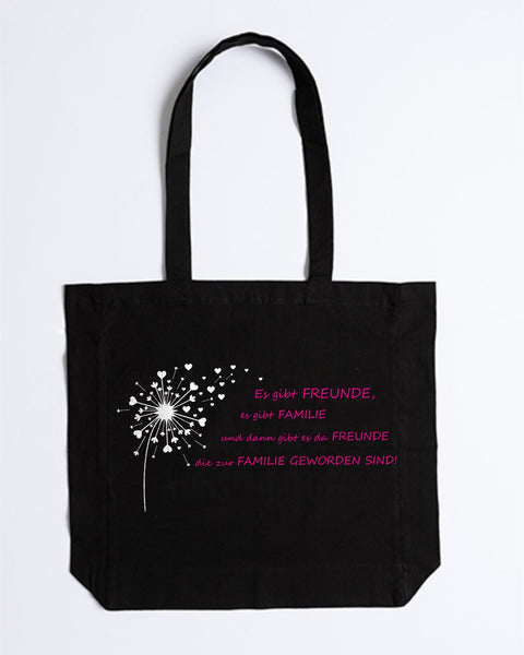 Stofftasche „Es gibt Freunde, es gibt Familie“ in Schwarz mit weißer Pusteblume und pinkem Spruch