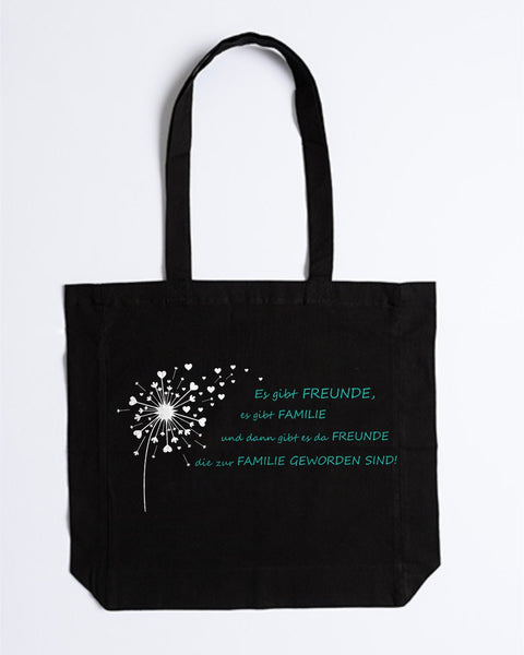 Stofftasche „Es gibt Freunde, es gibt Familie“ in Schwarz mit weißer Pusteblume und türkisem Spruch