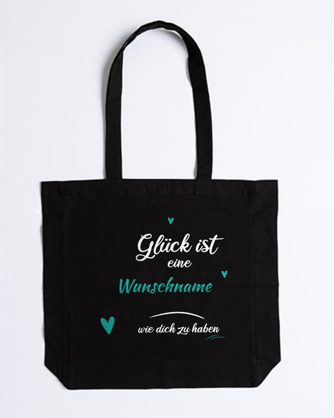 Stofftasche „Glück ist eine … wie dich zu haben“ mit Wunschname in Schwarz – Wunschname und Herzen in Türkis