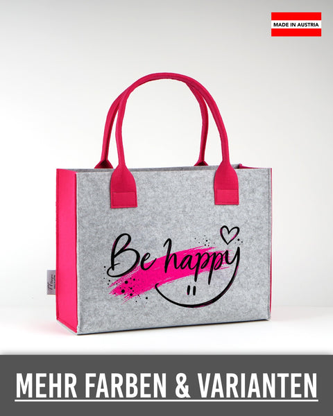 Filztasche „Be happy“ mit schwarzer Schrift in Hellgrau mit pinken Seiten und Henkeln
