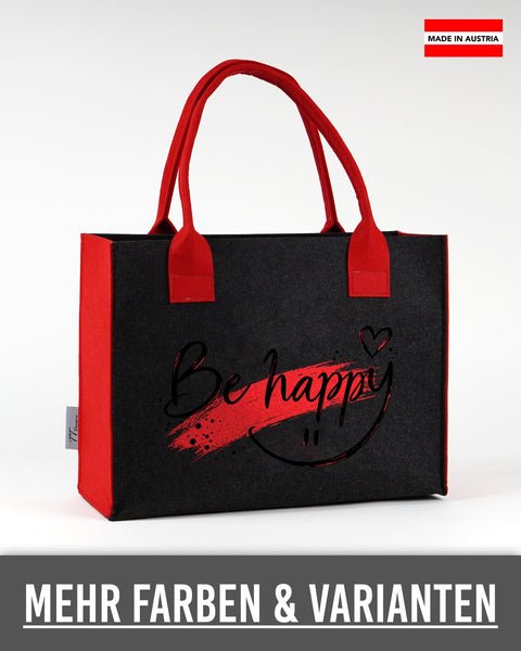 Filztasche „Be happy“ mit schwarzer Schrift in Dunkelgrau mit roten Seiten und Henkeln