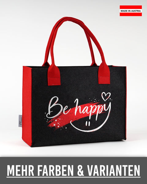 Filztasche „Be happy“ mit weißer Schrift in Dunkelgrau mit roten Seiten und Henkeln